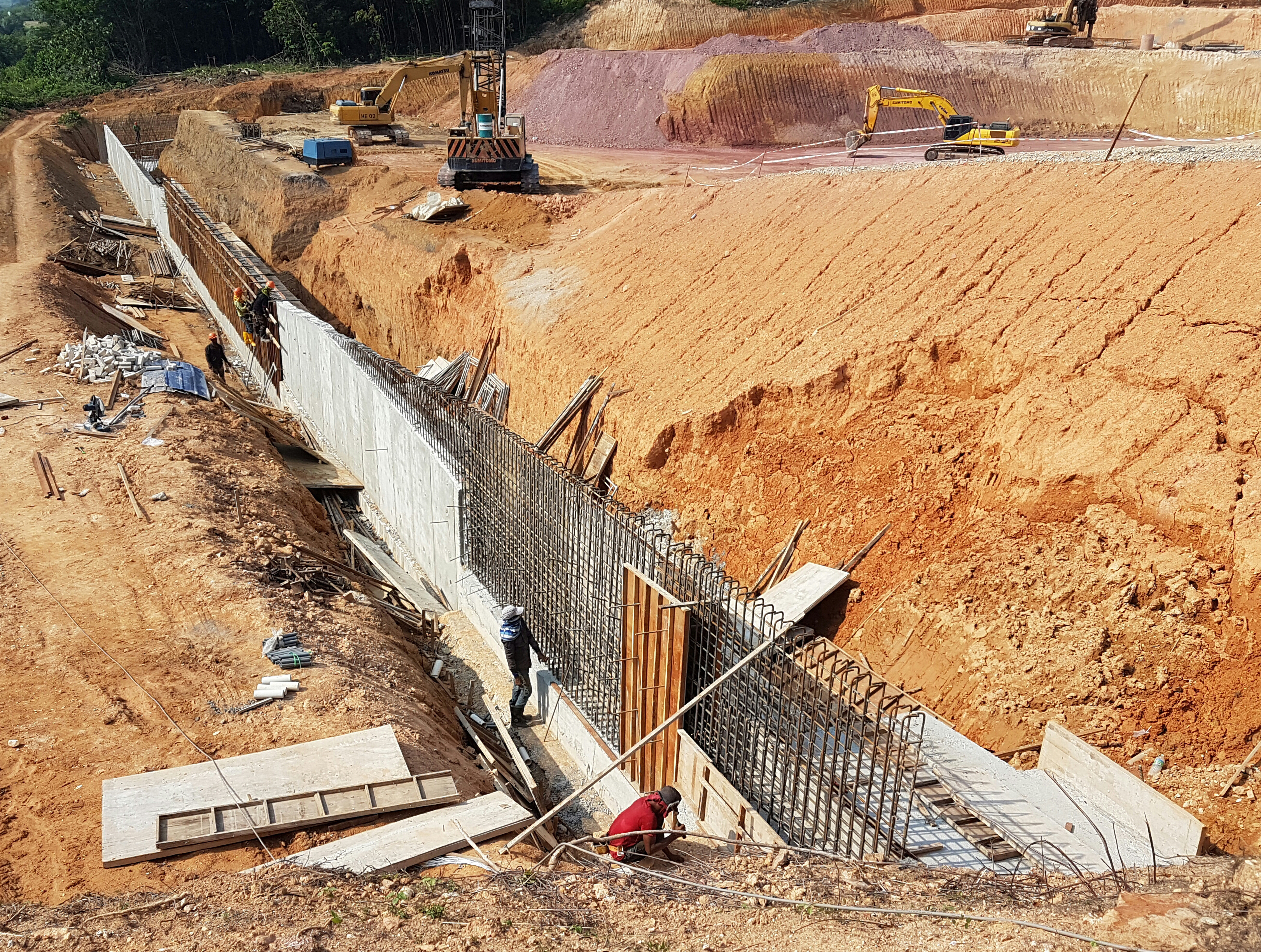 Adobe image of a reinforced concrete retaining wall construction in progress.